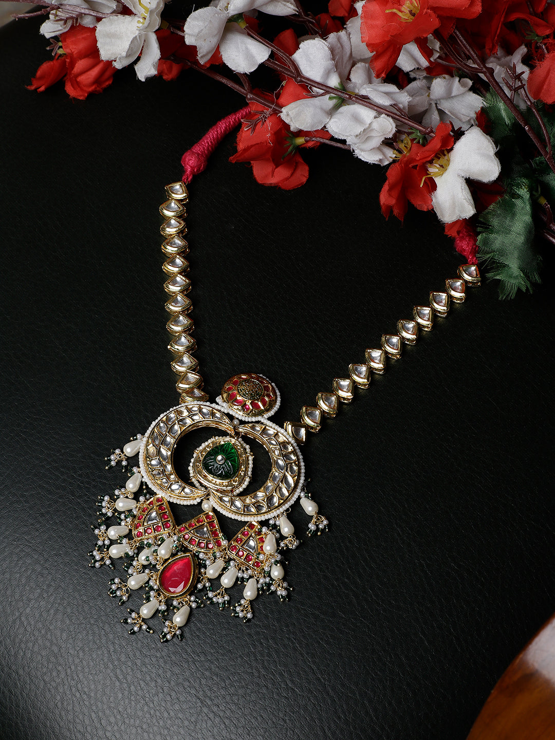 Multi shaped Kundan Necklace with Green Carved Stone and small Pearl hangings