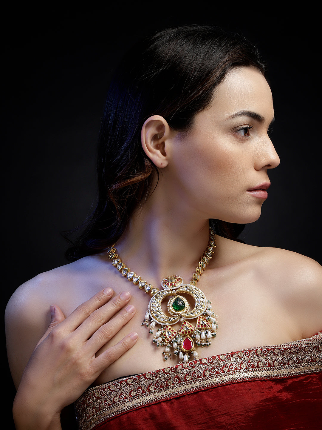 Multi shaped Kundan Necklace with Green Carved Stone and small Pearl hangings