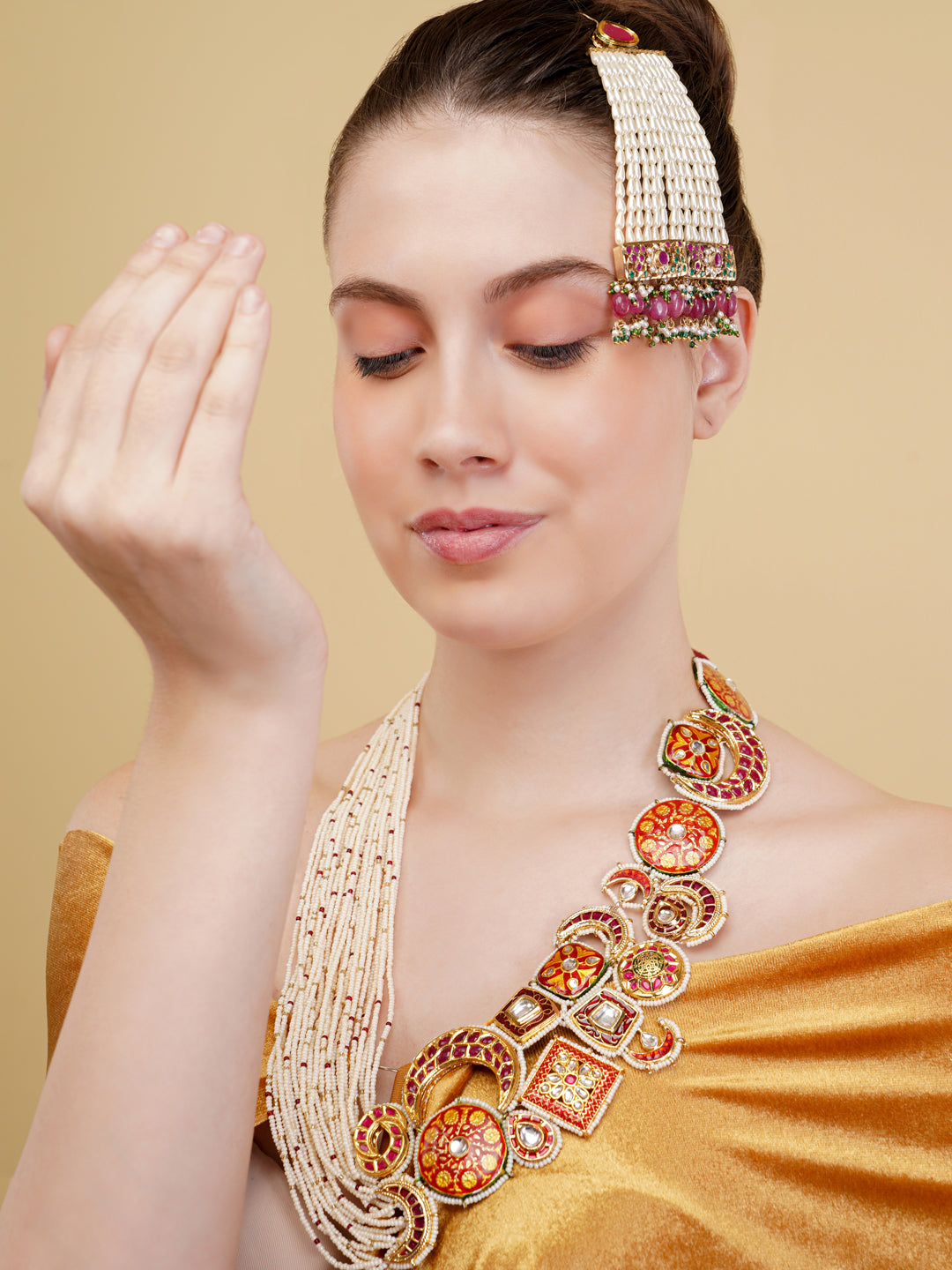 Designer necklace woith meenakari tikras alsong with kundan tikras joined togather with pearls strings